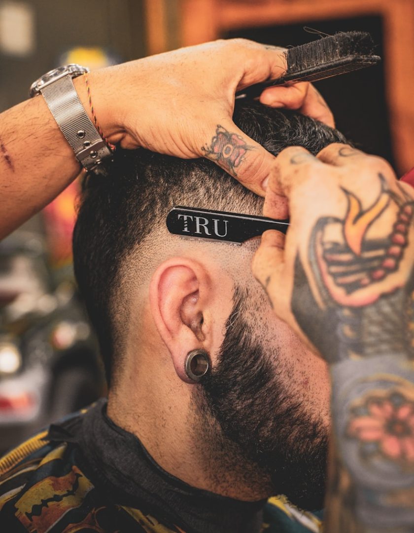 man in black shirt with tattoo on his left arm